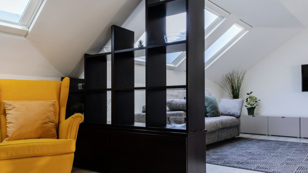 a living room with a yellow chair and a flat screen tv